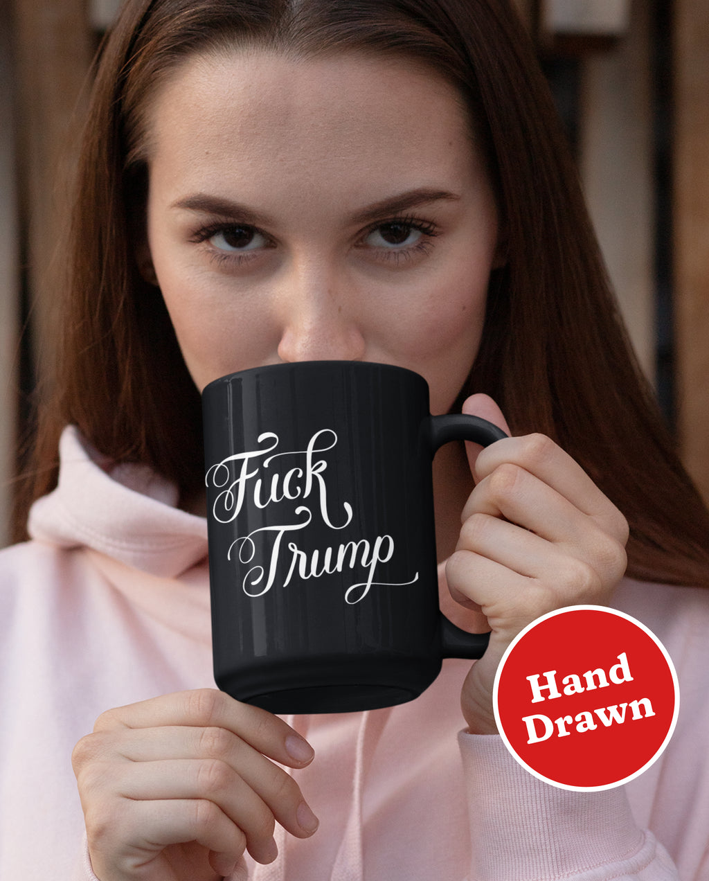 A YUGE 15oz black ceramic mug with the words "Fuck Trump" in hand-drawn calligraphy for Anti-Trump liberal democrats who love coffee. Perfect for enjoying some covfefe while battling MAGA in the comments sections. Microwave & Dishwasher Safe.