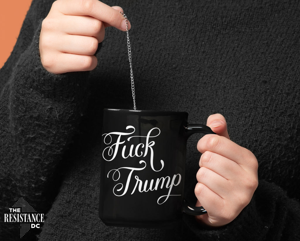 A YUGE 15oz black ceramic mug with the words "Fuck Trump" in hand-drawn calligraphy for Anti-Trump liberal democrats who love coffee. Perfect for enjoying some covfefe while battling MAGA in the comments sections. Microwave & Dishwasher Safe.