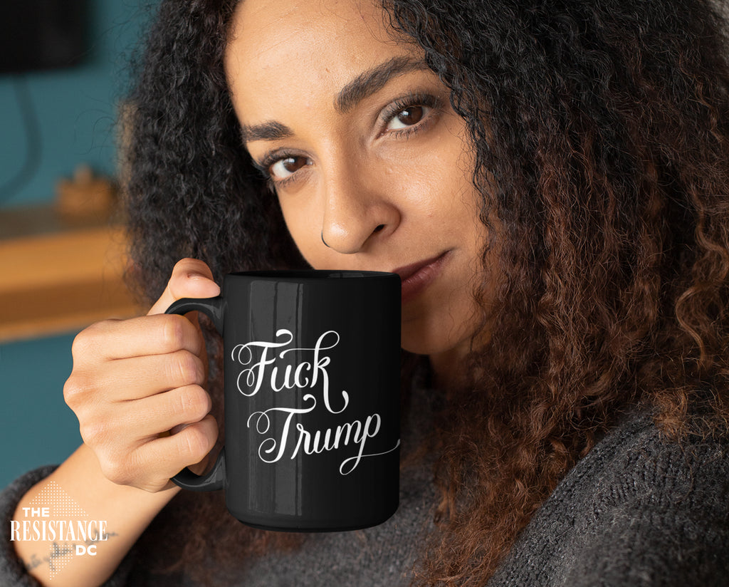 A YUGE 15oz black ceramic mug with the words "Fuck Trump" in hand-drawn calligraphy for Anti-Trump liberal democrats who love coffee. Perfect for enjoying some covfefe while battling MAGA in the comments sections. Microwave & Dishwasher Safe.