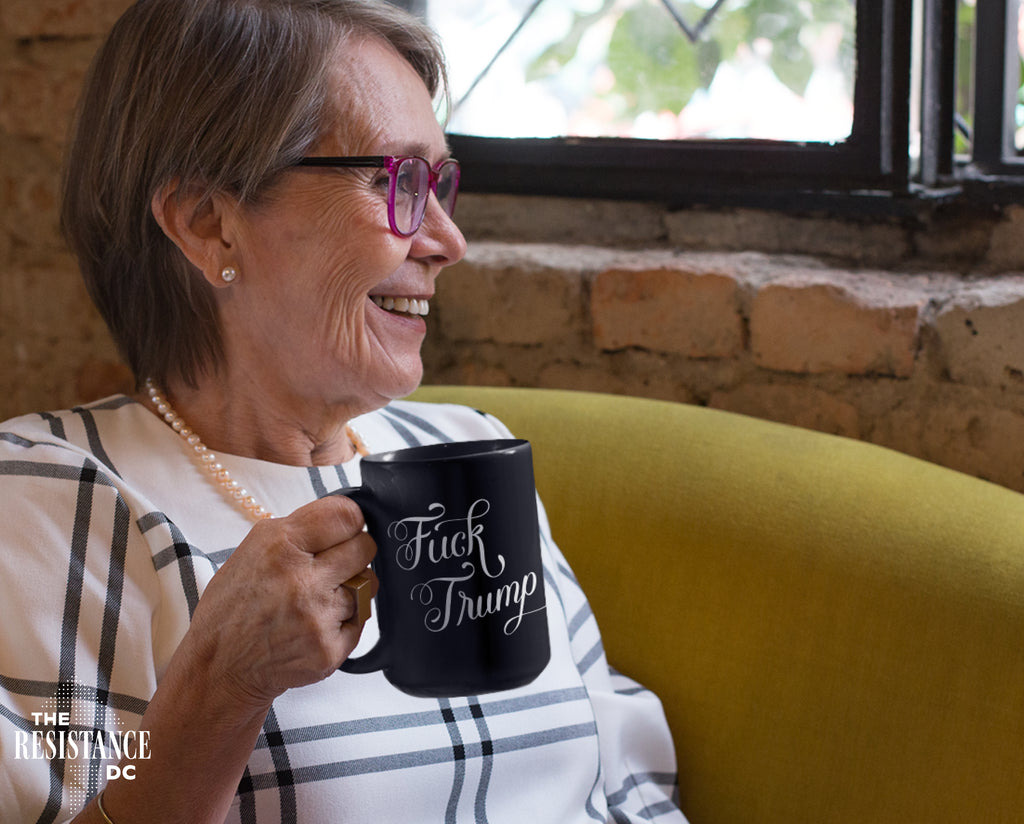 A YUGE 15oz black ceramic mug with the words "Fuck Trump" in hand-drawn calligraphy for Anti-Trump liberal democrats who love coffee. Perfect for enjoying some covfefe while battling MAGA in the comments sections. Microwave & Dishwasher Safe.