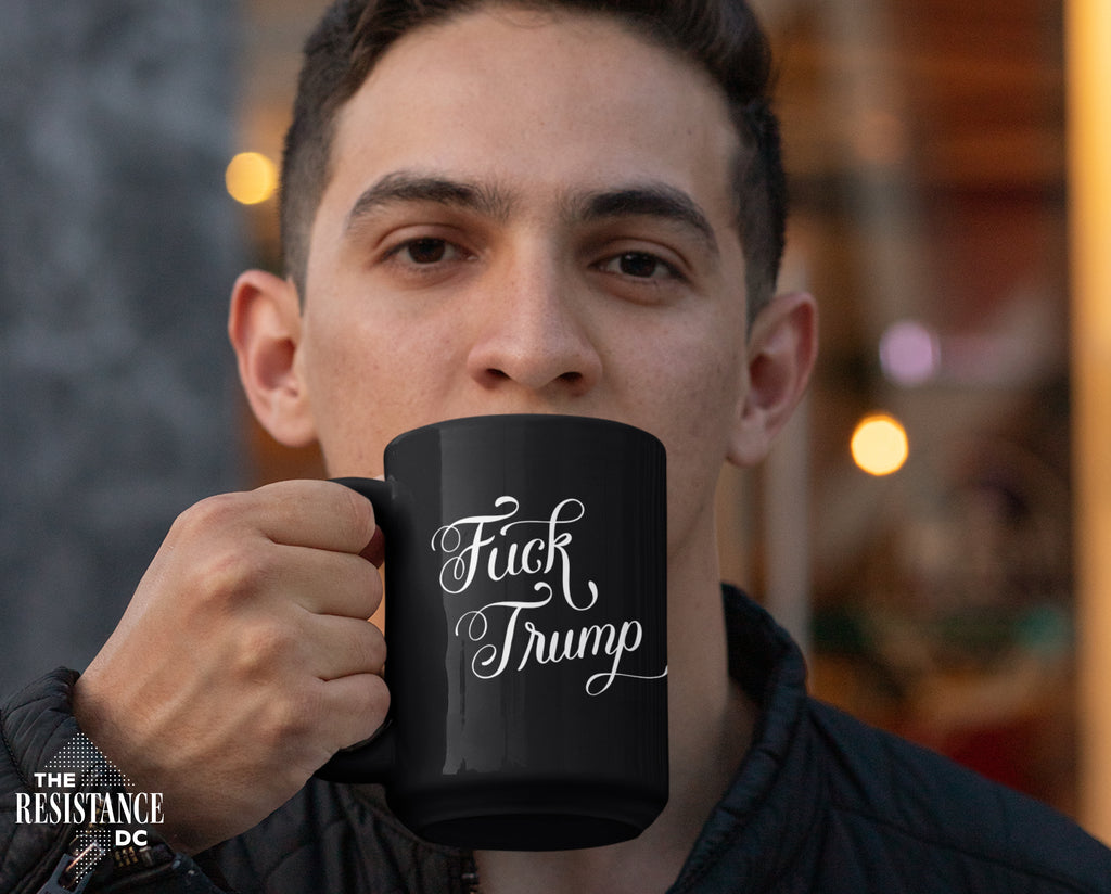 A YUGE 15oz black ceramic mug with the words "Fuck Trump" in hand-drawn calligraphy for Anti-Trump liberal democrats who love coffee. Perfect for enjoying some covfefe while battling MAGA in the comments sections. Microwave & Dishwasher Safe.