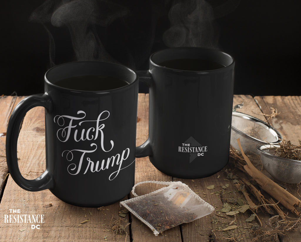 A YUGE 15oz black ceramic mug with the words "Fuck Trump" in hand-drawn calligraphy for Anti-Trump liberal democrats who love coffee. Perfect for enjoying some covfefe while battling MAGA in the comments sections. Microwave & Dishwasher Safe.