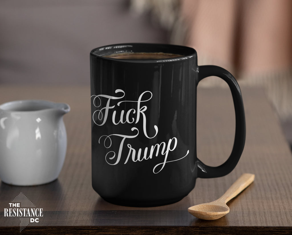 A YUGE 15oz black ceramic mug with the words "Fuck Trump" in hand-drawn calligraphy for Anti-Trump liberal democrats who love coffee. Perfect for enjoying some covfefe while battling MAGA in the comments sections. Microwave & Dishwasher Safe.